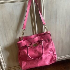 Hot pink Michael Kors bag and wallet with extra strap.